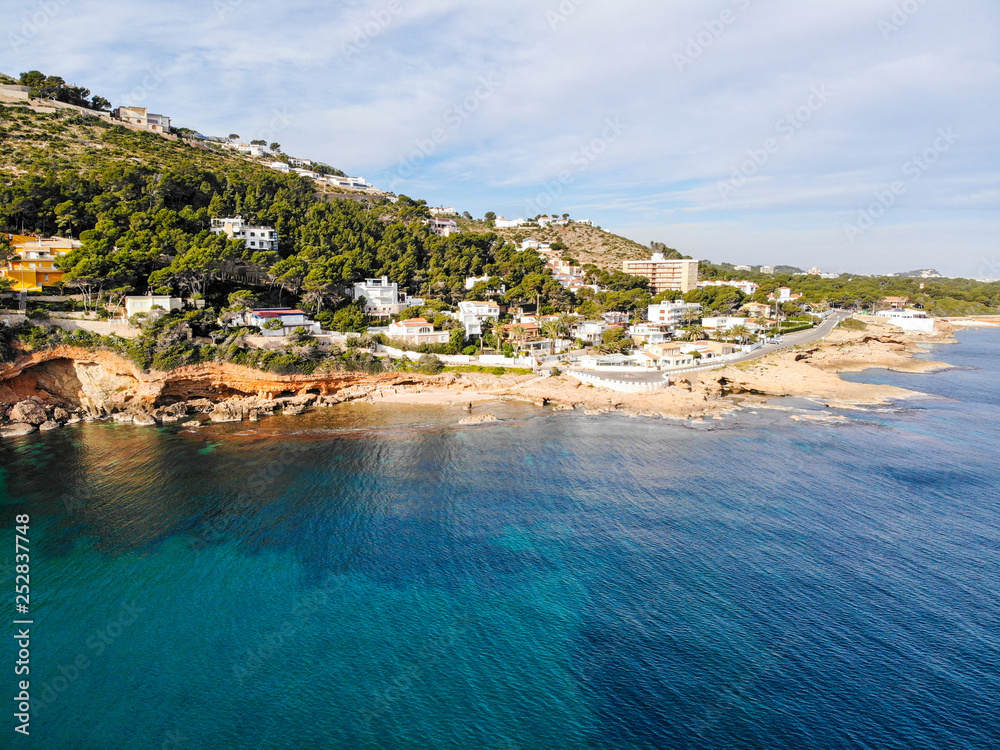 Aerial view of Las Rotas rocky beach in Denia, Spain at sunset