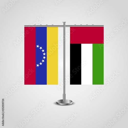 Table stand with flags of Venezuela and United Arab Emirates. Two flag. Flag pole. Symbolizing the cooperation between the two countries. Table flags