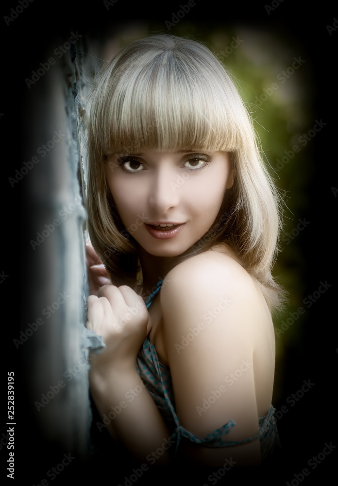 Fototapeta premium Beautiful sexual girl blonde beside sulphur concrete wall
