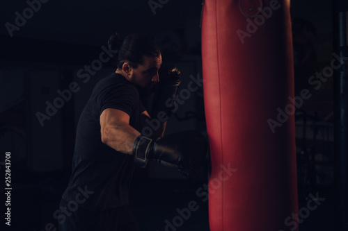 Boxer hitting the heavy bag with right hook © sasamihajlovic