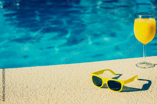 Holidays glamorous blogger kept women - idle lifestyle - poolside cocktail and sunglasses