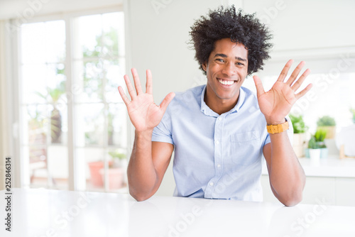 African American business man showing and pointing up with fingers number ten while smiling confident and happy.