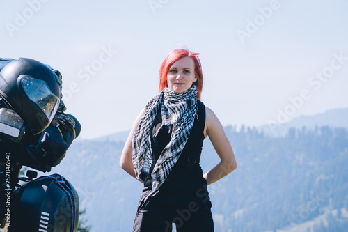 portrait of woman biker with adventure motorcycle, tourism travel concept, motorcyclists way, copy space beautiful sunny day photo