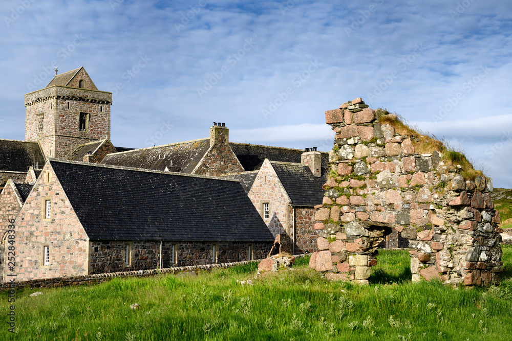 Medieval pink granite stone ruins of the Bishop's House next to the museum at Iona Abbey monastery on Isle of Iona Inner Hebrides Scotland UK Medieval pink granite stone ruins of the Bishop's House next to the museum at Iona Abbey monastery on Isle of Iona Inner Hebrides Scotland UK