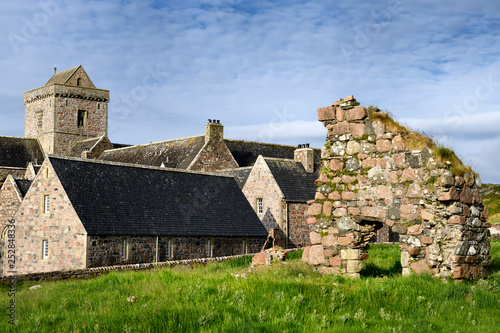 Photos Medieval pink granite stone ruins of the Bishop's House next to the museum at Io