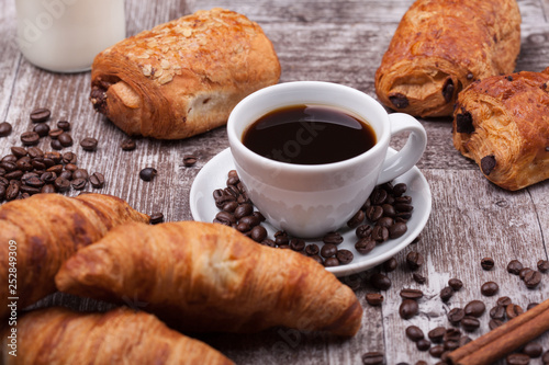 Cup of Coffee with Pastry on rustic wood table background