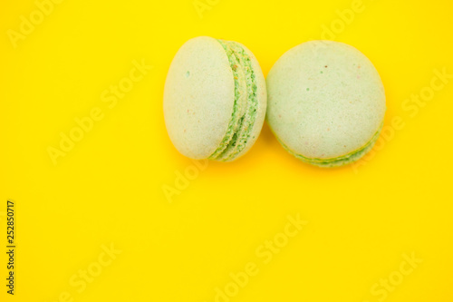 Top view of green tea flavour macaroons over yellow background