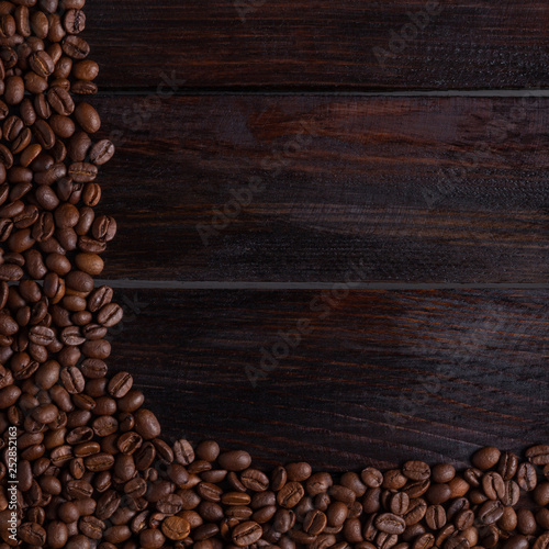 Coffee grains on a dark wooden background. Photo top view