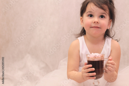 funny girl in ballerina tutu with a glass of hot drink in her hands