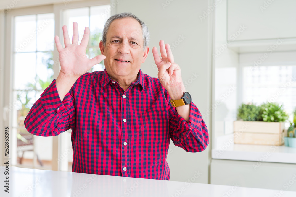 Handsome senior man at home showing and pointing up with fingers number eight while smiling confident and happy. Handsome senior man at home showing and pointing up with fingers number eight while smiling confident and happy.