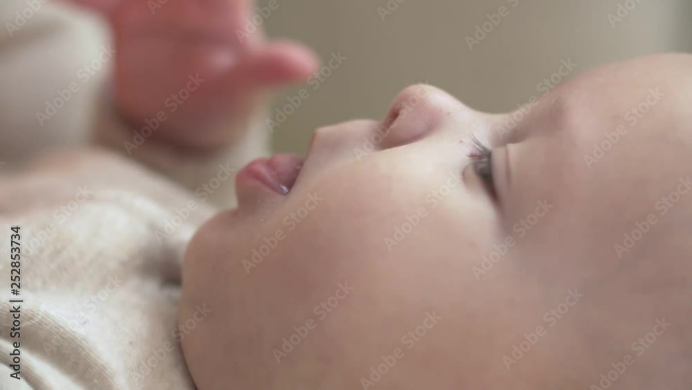 Mother play funny caress and strokes her little baby nose. Close up view in slow motion. Motherhood concept. Mother play funny caress and strokes her little baby nose. Close up view in slow motion. Motherhood concept.