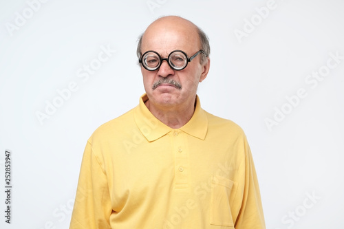 senior hispanic man looking at camera wearing funny glasses © Viktor Koldunov