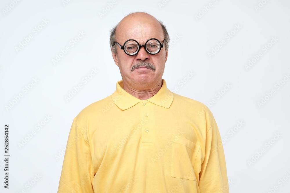 senior hispanic man looking at camera wearing funny glasses senior hispanic man looking at camera wearing funny glasses