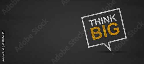 Think big and speech bubble on a blackboard
