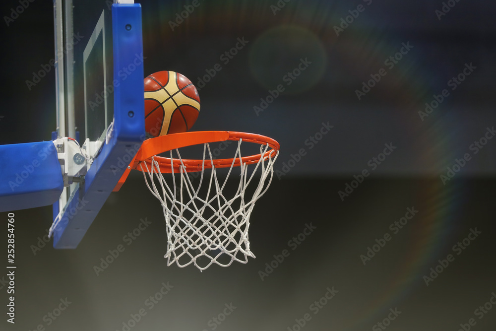 Basketball ball flies into the basketball hoop. Toned