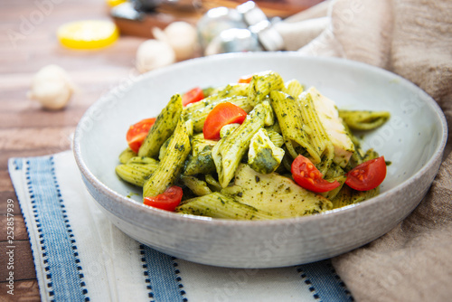 Pasta with pesto sauce and nuts on a the table