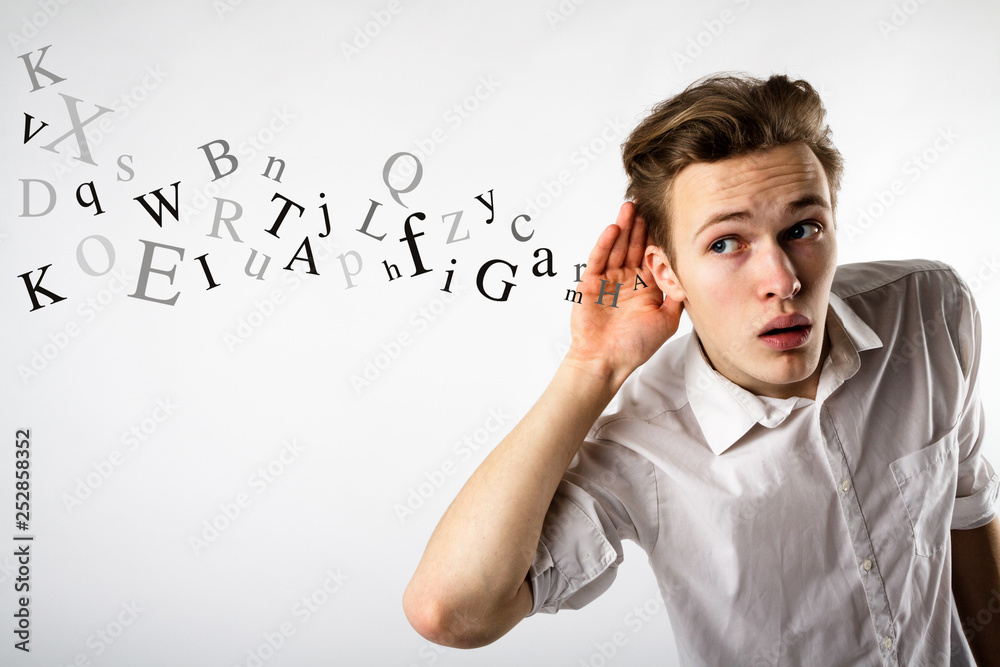 Curious young man in white. Curious man and letters. Information concept. Curious young man in white. Curious man and letters. Information concept.