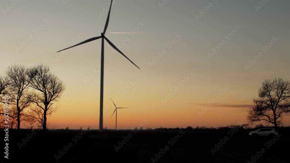 wind power plants at sunset. wind generators at work wind power plants at sunset. wind generators at work