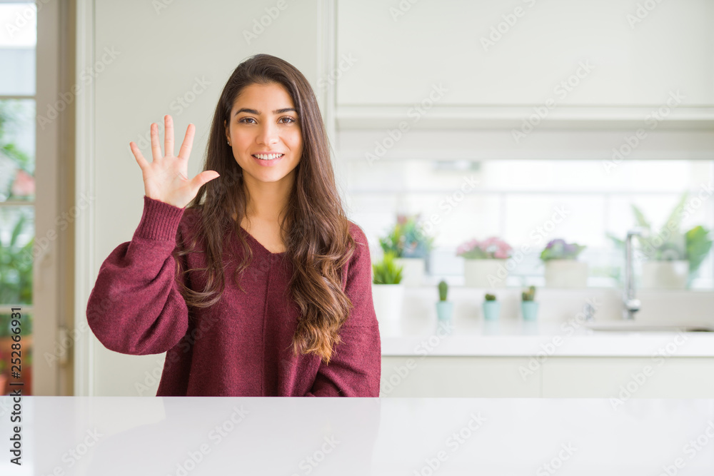 Young beautiful woman at home showing and pointing up with fingers number five while smiling confident and happy. Young beautiful woman at home showing and pointing up with fingers number five while smiling confident and happy.
