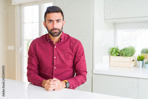 Handsome hispanic business man depressed and worry for distress, crying angry and afraid. Sad expression. © Krakenimages.com