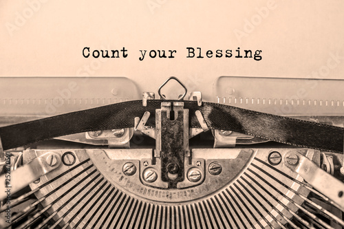 Count your Blessings printed on a sheet of paper on a vintage typewriter. writer, journalist.
