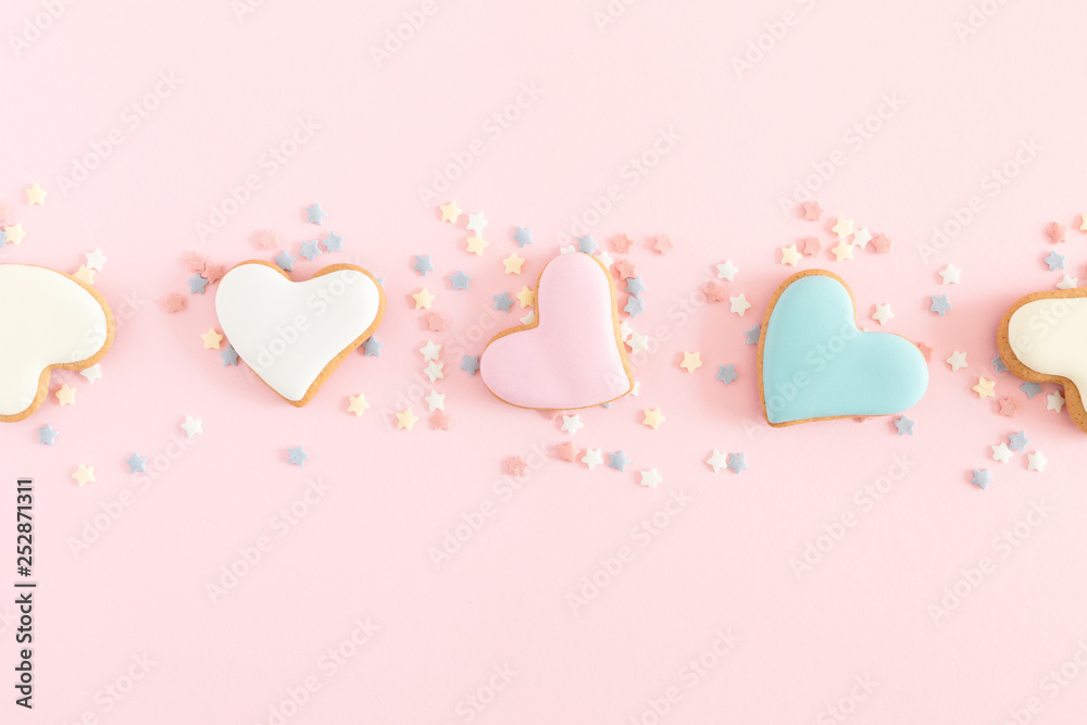 Valentine's day background. Ginger cookie in shape heart on pastel pink background. Valentine day concept, design. Flat lay, top view, copy space