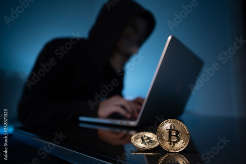 Hacker try to hack bitcoin blockchain system with laptop in dark room