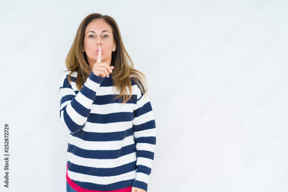 Beautiful middle age woman wearing navy sweater over isolated background asking to be quiet with finger on lips. Silence and secret concept. Beautiful middle age woman wearing navy sweater over isolated background asking to be quiet with finger on lips. Silence and secret concept.