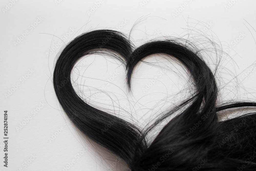 Fototapeta premium hair in the shape of a heart on a white background