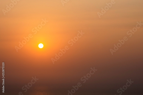 The morning sun light reflects the sea and fishing boats.