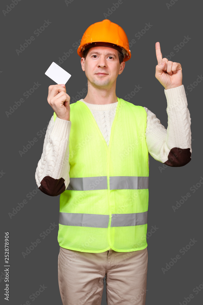 The designer keeps the bank plastic card in a helmet, raised a forefinger up