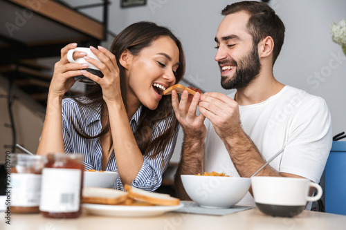 Happy multiethnic couple having breakfast