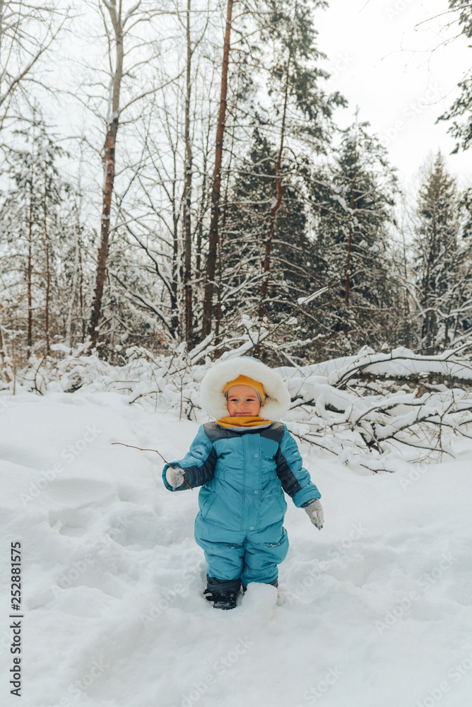 A child for a walk in the winter. Family walks in nature in winter. Family walk. Winter forest. Snow park.