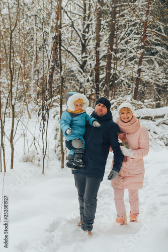 Walking family with a child. Family walks in nature in winter. Winter family walk in nature. A lot of snow. © Илона Удалова