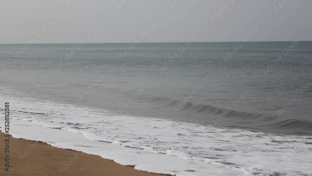sea waves at the sandy beach against the background of the ocean sea waves at the sandy beach against the background of the ocean