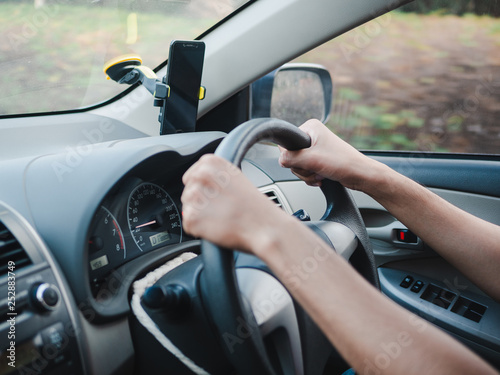Man holding steering wheel, driving on the road