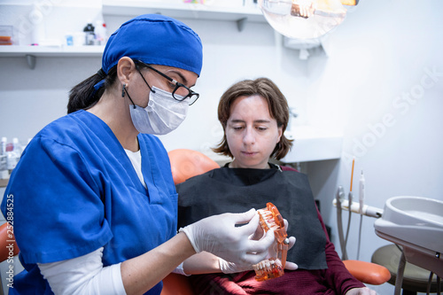 female dentist talking with a patient