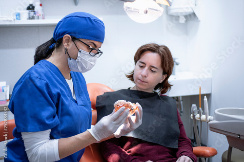 female dentist talking with a patient
