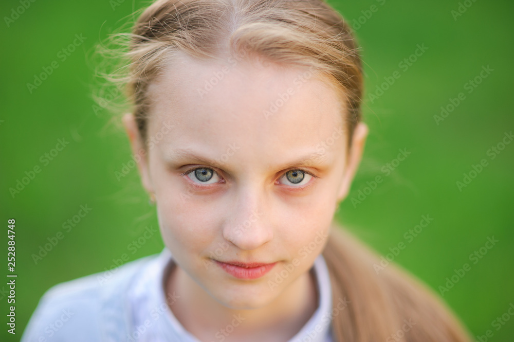 closeup portrait of beautiful blonde healthy little caucasian girl with clear skin on green outdoor spring background closeup portrait of beautiful blonde healthy little caucasian girl with clear skin on green outdoor spring background