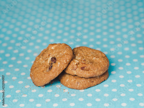 Oatmeal and raisin cookies on pastel blue polka dot background.