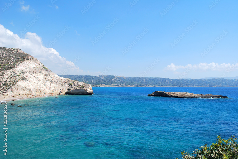 Coastal cliffs on the background of the island and blue sky, Cape Fourni, Rhodes Island, Greece