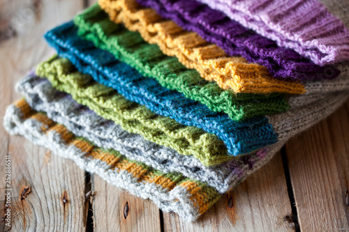 Multicolor knitted hats stack photo