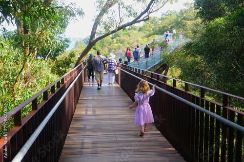 girl walking on bridge in park