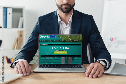 Canvas-taulu cropped view of advisor in suit showing laptop with sportsbet website on screen