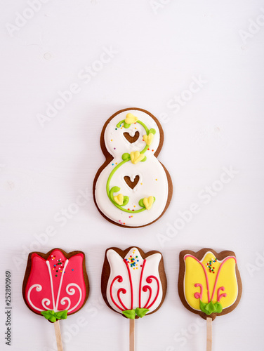 Homemade gingerbread cookies for March 8th in shape of tulips and number 8