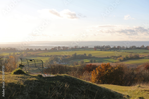 Seat overlooking Gloucestershire countryside photo