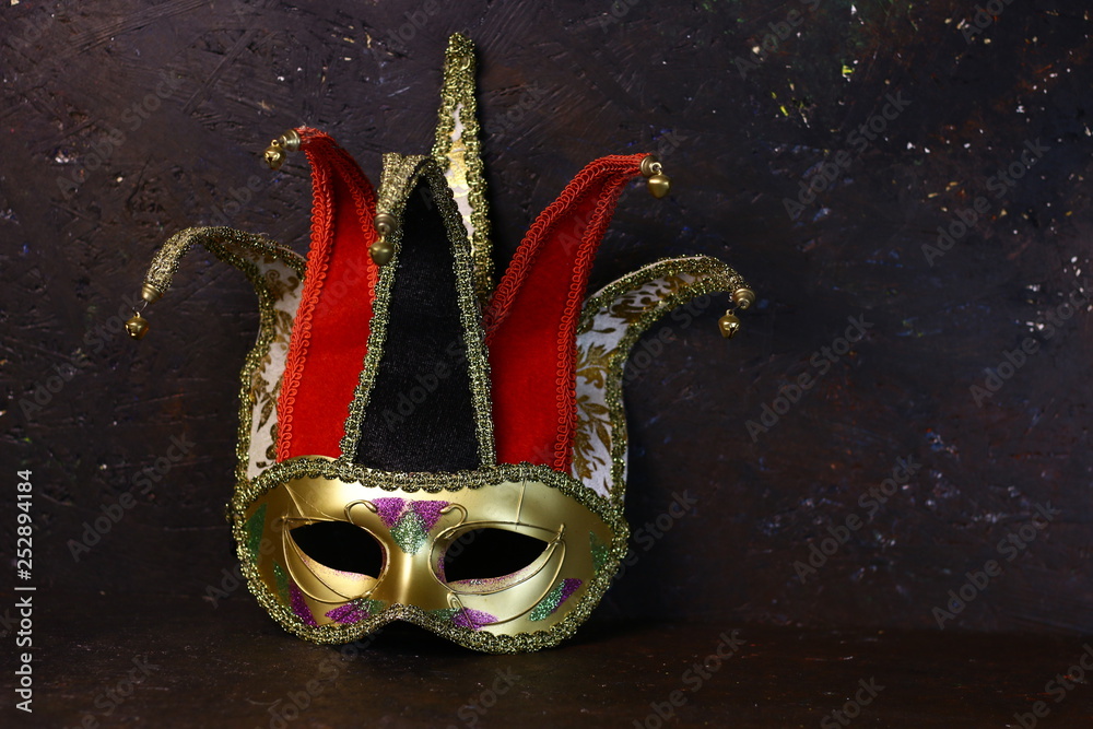 Carnival venetian Joker mask on dark background. Carnival mask front view.  Stock Photo | Adobe Stock