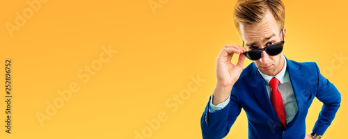 portrait of funny skeptic young businessman in sunglasses