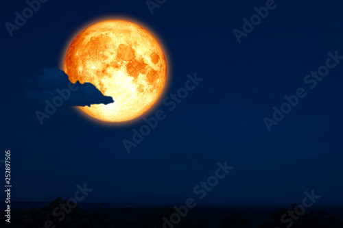 full egg moon back on silhouette mountain on night sky