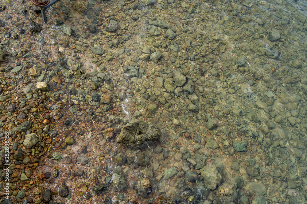 Top view of sea water surface with rock Top view of sea water surface with rock